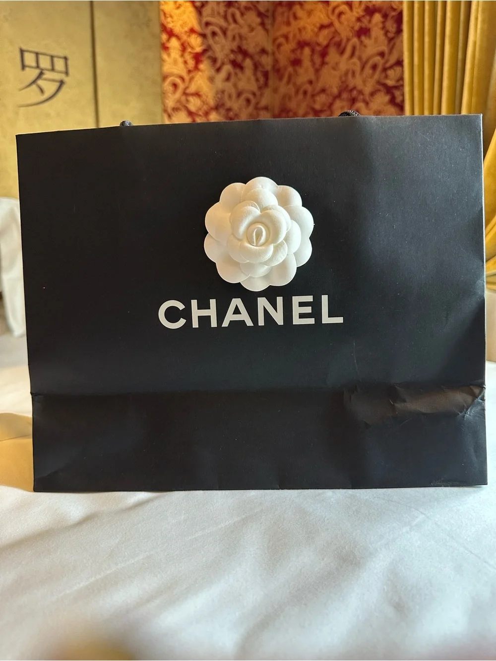CHANEL White Camellia Hair Accessory and shopping bag